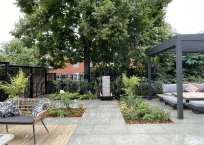 A gentle running of water from the water feature adds a calming effect to the garden.