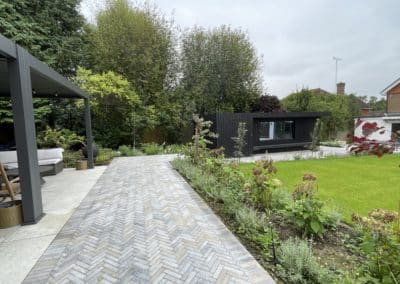 Limestone pavers were laid in a herringbone pattern to contrast with the smooth porcelain paving. The different textures showed off the different areas of the hard landscaping.