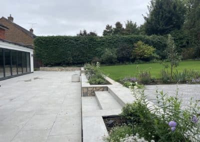 New patio with porcelain steps leading to the rest of the garden