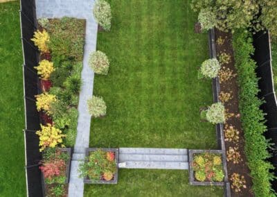 Stunning autumn colour in the plants showing off the straight lines in this well maintained garden design.